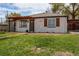 A charming home with a pergola and window shutters and a well-manicured lawn at 6220 W 11Th Pl, Lakewood, CO 80214