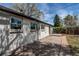 Exterior view of the house and yard showing the patio with seating at 6220 W 11Th Pl, Lakewood, CO 80214