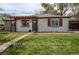 Charming single-story home featuring a pergola entrance and well-maintained front yard at 6220 W 11Th Pl, Lakewood, CO 80214