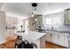 Bright kitchen with white cabinets, stainless steel appliances, and a quartz island at 6220 W 11Th Pl, Lakewood, CO 80214