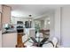 Bright, open kitchen with adjacent dining area, stainless steel appliances, and center island at 6220 W 11Th Pl, Lakewood, CO 80214