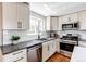 Well-equipped kitchen features stainless steel appliances and custom cabinetry at 6220 W 11Th Pl, Lakewood, CO 80214