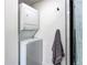 Space-saving stackable washer and dryer with a nearby towel rack for a streamlined and efficient laundry setup at 6220 W 11Th Pl, Lakewood, CO 80214