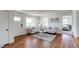 Comfortable living room with hardwood floors, neutral decor, and ample seating at 6220 W 11Th Pl, Lakewood, CO 80214