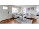 Inviting living room featuring hardwood floors, neutral furniture, and natural light at 6220 W 11Th Pl, Lakewood, CO 80214