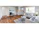 Cozy living room with hardwood flooring, neutral furniture, and ample natural light at 6220 W 11Th Pl, Lakewood, CO 80214