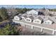 An aerial view of townhomes with well-maintained roofs, private garages, and mature trees surrounding the property at 12327 E Tennessee Dr # 107, Aurora, CO 80012