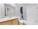 A standard bathroom features an oak vanity, toilet, and tub shower at 12327 E Tennessee Dr # 107, Aurora, CO 80012