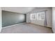 Bright bedroom with neutral carpet and large window with curtains at 12327 E Tennessee Dr # 107, Aurora, CO 80012
