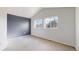 Bedroom with gray accent wall, carpeted floors, and two windows with tree views at 12327 E Tennessee Dr # 107, Aurora, CO 80012