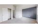 Bedroom featuring neutral carpet, closet and gray accent wall for a modern touch at 12327 E Tennessee Dr # 107, Aurora, CO 80012