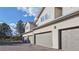 A well-maintained townhome exterior featuring garages and windows providing natural light, with clear skies above at 12327 E Tennessee Dr # 107, Aurora, CO 80012
