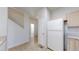 Bright kitchen area featuring tiled floors, a white refrigerator, and access to other areas of the home at 12327 E Tennessee Dr # 107, Aurora, CO 80012