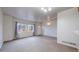 Bright living room with neutral carpet, white walls, and natural light at 12327 E Tennessee Dr # 107, Aurora, CO 80012