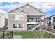 Charming two-story home featuring a gray siding exterior and a well-maintained fenced backyard at 7242 Canyon Sky Trl, Castle Pines, CO 80108