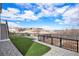 Spacious backyard with turf grass, garden beds, and views of the surrounding neighborhood and landscape at 7242 Canyon Sky Trl, Castle Pines, CO 80108