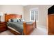 Bedroom featuring wood furniture and a large window at 7242 Canyon Sky Trl, Castle Pines, CO 80108