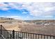 Picturesque community view from a home's upper level, showcasing the neighborhood and the lake at 7242 Canyon Sky Trl, Castle Pines, CO 80108