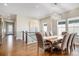 Bright dining room with wood floors, modern chandelier, and staircase leading to the second floor at 7242 Canyon Sky Trl, Castle Pines, CO 80108