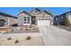 Charming two-story home with a brick and siding exterior and well-manicured front yard at 7242 Canyon Sky Trl, Castle Pines, CO 80108