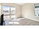 Bright living room featuring large windows, light walls, and wood-look floors at 7242 Canyon Sky Trl, Castle Pines, CO 80108