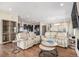 Inviting living room with hardwood floors and neutral-toned furniture, leading to open kitchen and dining areas at 7242 Canyon Sky Trl, Castle Pines, CO 80108