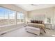 Serene main bedroom featuring large windows, neutral decor, and a cozy upholstered bed frame at 7242 Canyon Sky Trl, Castle Pines, CO 80108