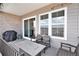 Relaxing outdoor patio with a dining set, grill, and sliding doors for seamless indoor-outdoor living at 7242 Canyon Sky Trl, Castle Pines, CO 80108