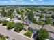Aerial view of a residential neighborhood with tree-lined streets and solar panels at 11082 Fillmore Way, Northglenn, CO 80233