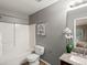 Cozy bathroom with a tub and shower, a decorative mirror and coordinated fixtures at 11082 Fillmore Way, Northglenn, CO 80233