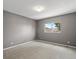 Empty bedroom with neutral carpet, gray walls, a window and overhead lighting at 11082 Fillmore Way, Northglenn, CO 80233