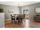 Elegant dining area with hardwood floors, modern lighting, and access to the outdoor space at 11082 Fillmore Way, Northglenn, CO 80233