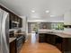 Spacious kitchen with dark wood cabinets, stainless steel appliances, and hardwood floors at 11082 Fillmore Way, Northglenn, CO 80233