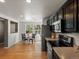 Open kitchen featuring stainless steel appliances, dark cabinets, and an adjacent dining area at 11082 Fillmore Way, Northglenn, CO 80233