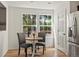 Bright kitchen nook with hardwood floors, a dining table, and natural light from large windows at 11082 Fillmore Way, Northglenn, CO 80233