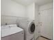 Bright laundry room with white washer and dryer at 11082 Fillmore Way, Northglenn, CO 80233