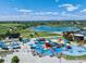 Vibrant community playground with colorful structures and a scenic lake backdrop at 11082 Fillmore Way, Northglenn, CO 80233