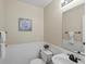 This powder room features wainscoting, a decorative mirror and a new toilet and sink at 11082 Fillmore Way, Northglenn, CO 80233