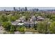 An aerial view of a neighborhood with a city skyline in the background on a sunny day at 1016 31St St, Denver, CO 80205