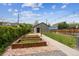 Landscaped backyard features brick patio and raised garden beds, offering serene outdoor space at 1016 31St St, Denver, CO 80205