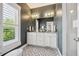 Modern bathroom featuring double vanity, stylish mirrors, and a bright window at 1016 31St St, Denver, CO 80205