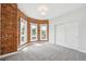 Bright bedroom with exposed brick and multiple windows at 1016 31St St, Denver, CO 80205