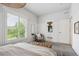 Bright bedroom with window views, comfortable seating, and access to an ensuite bathroom at 1016 31St St, Denver, CO 80205
