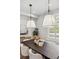 Bright dining room featuring modern chandelier, wooden table, and window views at 1016 31St St, Denver, CO 80205
