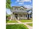 Charming two-story home features a covered front porch and a well-manicured lawn at 1016 31St St, Denver, CO 80205