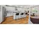 Stylish kitchen with stainless appliances, island with seating, and open to dining space at 1016 31St St, Denver, CO 80205
