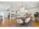 Open concept dining area and kitchen with modern white cabinets and stainless steel appliances at 1016 31St St, Denver, CO 80205