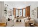 Cozy living room with exposed brick accent wall, built-in shelving, and ample natural light at 1016 31St St, Denver, CO 80205