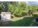 The backyard has a storage shed and lush green grass at 6073 W Adriatic Pl, Lakewood, CO 80227