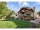 A charming home featuring a covered patio and a lush green lawn at 6073 W Adriatic Pl, Lakewood, CO 80227